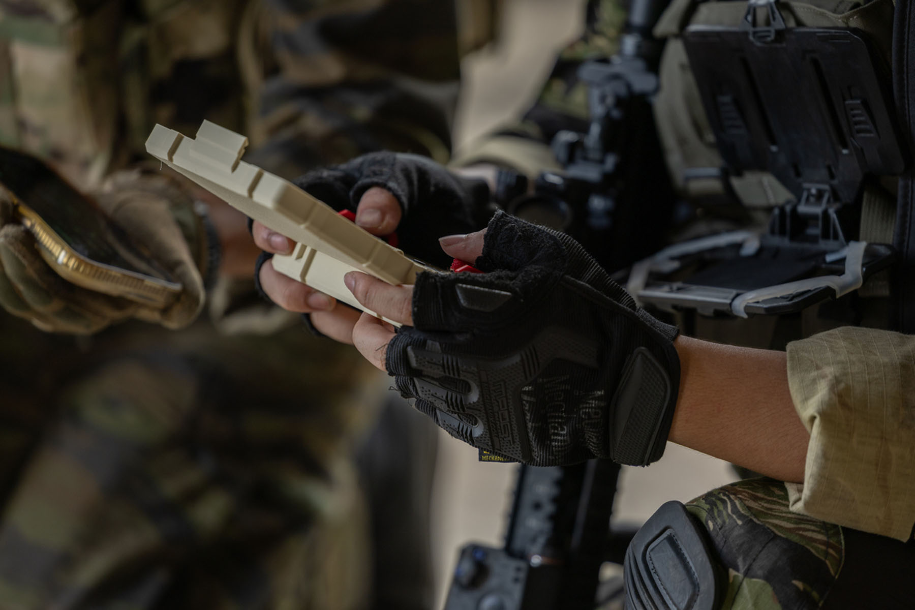 Soldier glove tablet tactical uniform camouflage gear communication field planning with handheld device during mission